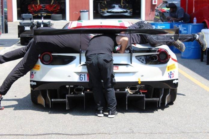 3 mechanics working on a Ferrari at SRO GT America VIR